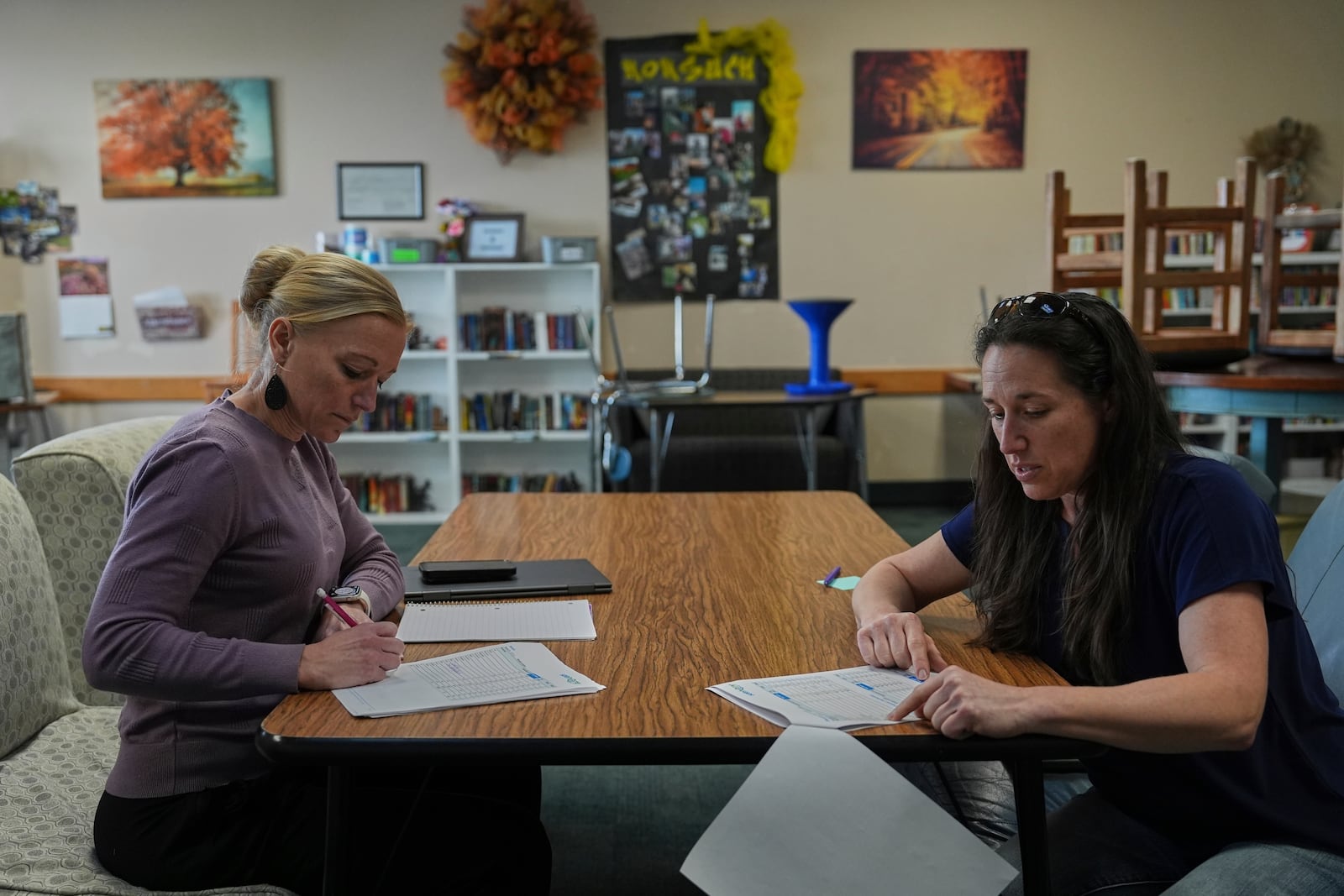 Abbie Brockman, right, goes through the results of a water quality test with colleague Karen LaMar, left, Thursday, April 10, 2025, in Leopold, Ind. (AP Photo/Joshua A. Bickel)