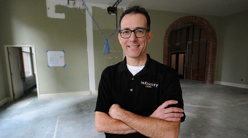 Harry Panson Jr., Program & Product Manager, for Infinity Labs stands in the expanded offices that are under construction at 15 W. 4th Street, in downtown Dayton. MARSHALL GORBY\STAFF