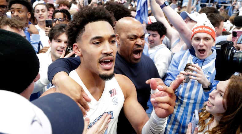 North Carolina guard Seth Trimble (7) celebrates with fans after an NCAA college basketball game against Duke, Saturday, Feb. 7, 2026, in Chapel Hill, N.C. (AP Photo/Chris Seward)