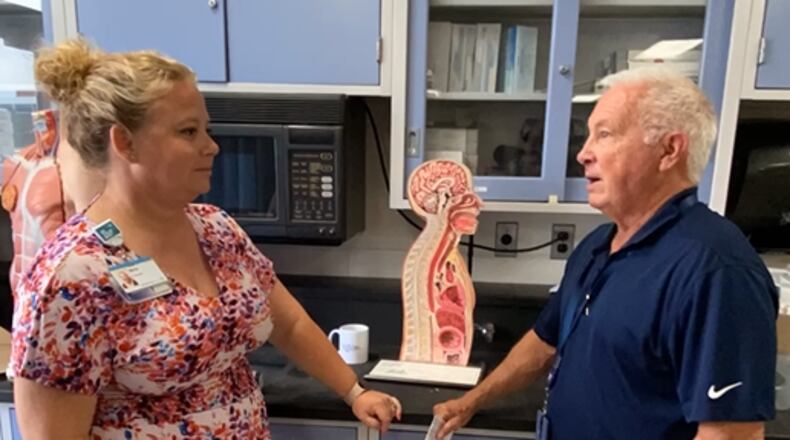 Dr. Tom Henderson checks in with Malia Pryor in the Allied Health program to see how he can help students and faculty with job placements and other program needs. CONTRIBUTED