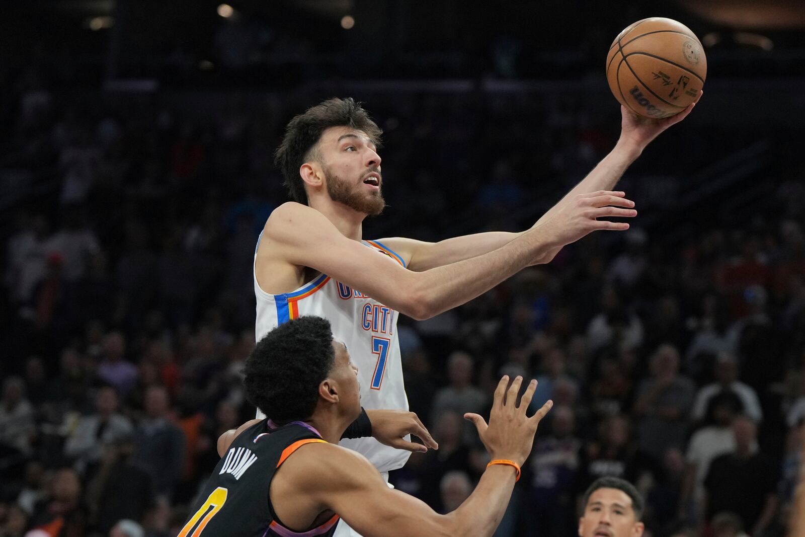 Oklahoma City Thunder forward Chet Holmgren (7) shoots over Phoenix Suns forward Ryan Dunn during the first half of an NBA basketball game, Wednesday, April 9, 2025, in Phoenix. (AP Photo/Rick Scuteri)