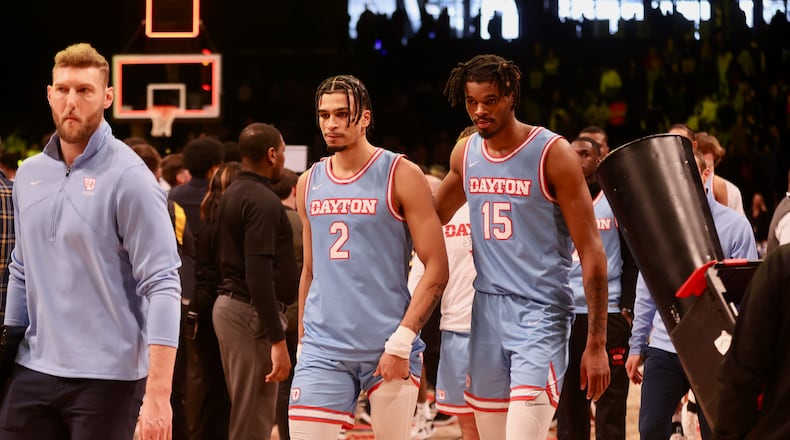 Dayton's Toumani Camara and DaRon Holmes II leave the court after a loss against Virginia Commonwealth in the Atlantic 10 Conference championship game on Saturday, March 12, 2023, at the Barclays Center in Brooklyn, N.Y. David Jablonski/Staff