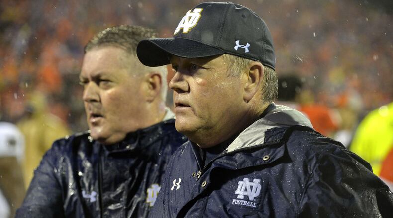 Notre Dame head coach Brian Kelly is escorted off of the field after an NCAA college football game against Clemson Saturday, Oct. 3, 2015, in Clemson, S.C. Clemson won 24-22. (AP Photo/Richard Shiro)