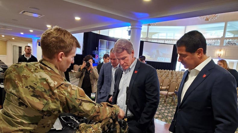1st Lt Patrick Assef (left), a special warfare mechanical engineer with the Air Force Research Laboratory, explains several Air Force programs to Lt. Gov. Jon Husted (center) of Ohio during the Air Force Life Cycle Management Center’s Pitch Day Nov.13-14, 2019.