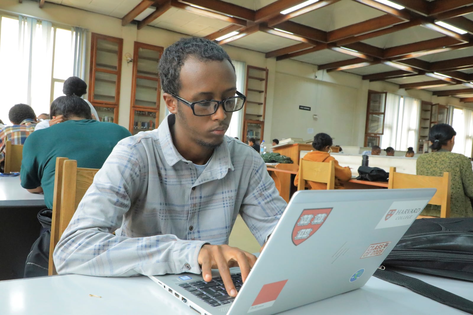 Yonas Nuguse, 21 years old, destined for Harvard University working on a computer at Wemezeker National Library in Addis Ababa, Ethiopia Friday, May 30, 2025. (AP Photo/Amanuel Birhane)