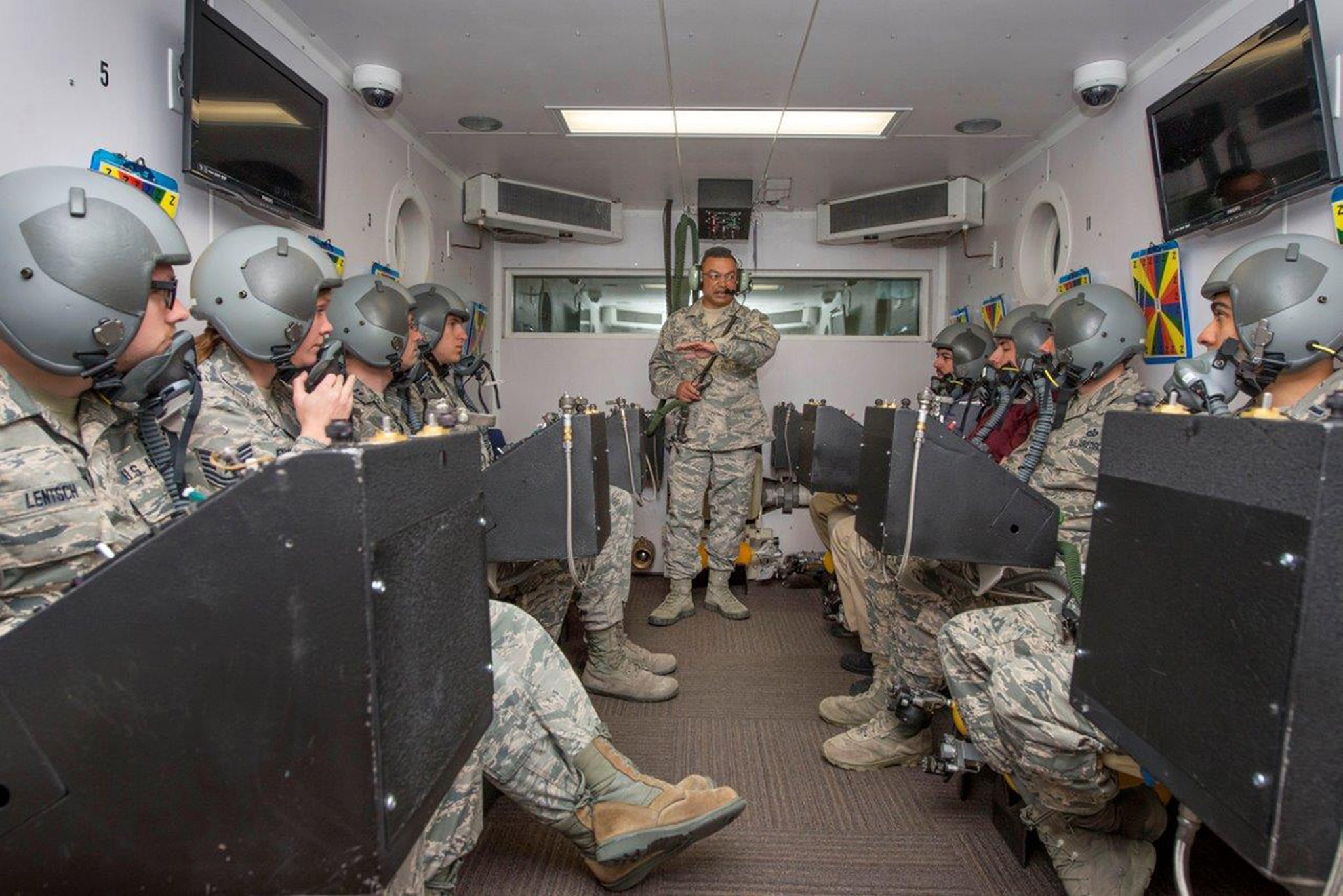 Senior Master Sgt. Paul Johal, United States Air Force School of Aerospace Medicine operational physiology superintendent, briefs students in the altitude hypobaric chamber about familiarizing themselves with the oxygen equipment for hypoxia demo training at Wright-Patterson Air Force Base on April 26. The hypobaric chamber provides a training system which replicates the effects of barometric pressure change on the human body. (U.S. Air Force photo/Michelle Gigante)