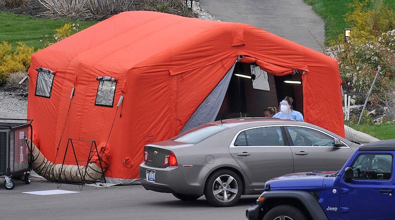 Kettering Health Network will participate in an expanded access clinical trial for the antiviral drug remdesivir, which has shown in preliminary trials helps coronavirus patients recover faster. Pictured is COVID-19 drive-through testing at the Kettering Medical Center in the Kettering College Parking lot, on Southern Blvd. MARSHALL GORBYSTAFF