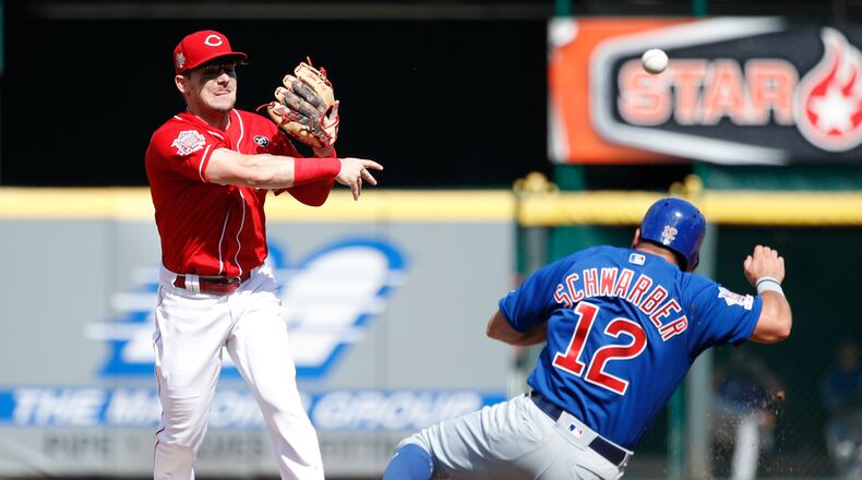 CINCINNATI, OH - JUNE 29: Scooter Gennett #3 of the Cincinnati Reds turns a double play over Kyle Schwarber #12 of the Chicago Cubs in the third inning at Great American Ball Park on June 29, 2019 in Cincinnati, Ohio. (Photo by Joe Robbins/Getty Images)