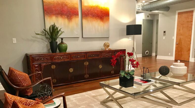 Orange and yellow tones in artwork help to warm the space. (Cathy Hobbs Design Recipes)