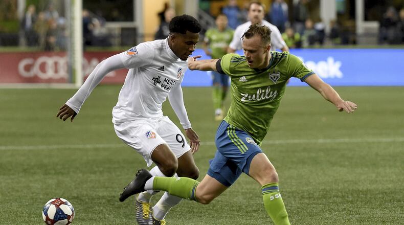 SEATTLE, WA - MARCH 02: Alvas Powell #92 of FC Cincinnati tries to get past Brad Smith #11 of the Seattle Sounders battle for a ball during the first half ot the match at CenturyLink Field on March 2, 2019 in Seattle, Washington. (Photo by Steve Dykes/Getty Images)