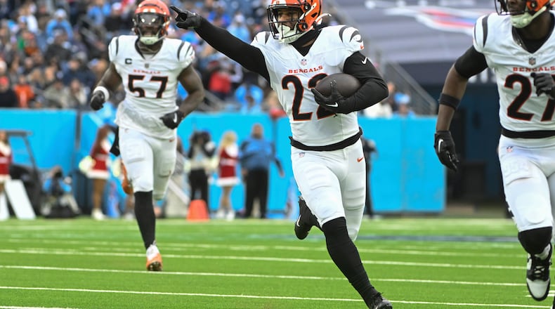 Cincinnati Bengals safety Geno Stone (22) points as he runs towards the endzone to score a touchdown during the second half of an NFL football game against the Tennessee Titans, Sunday, Dec. 15, 2024, in Nashville, Tenn. (AP Photo/John Amis)