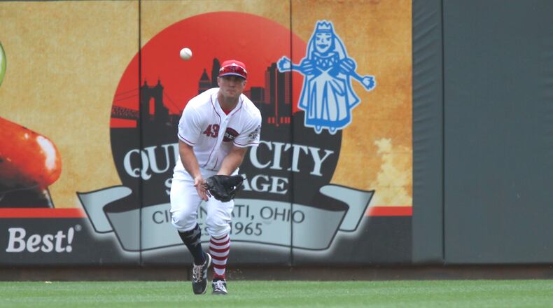 Reds right fielder Scott Schebler makes a catch against the Cubs on Sunday, July 2, 2017, at Great American Ball Park in Cincinnati. David Jablonski/Staff