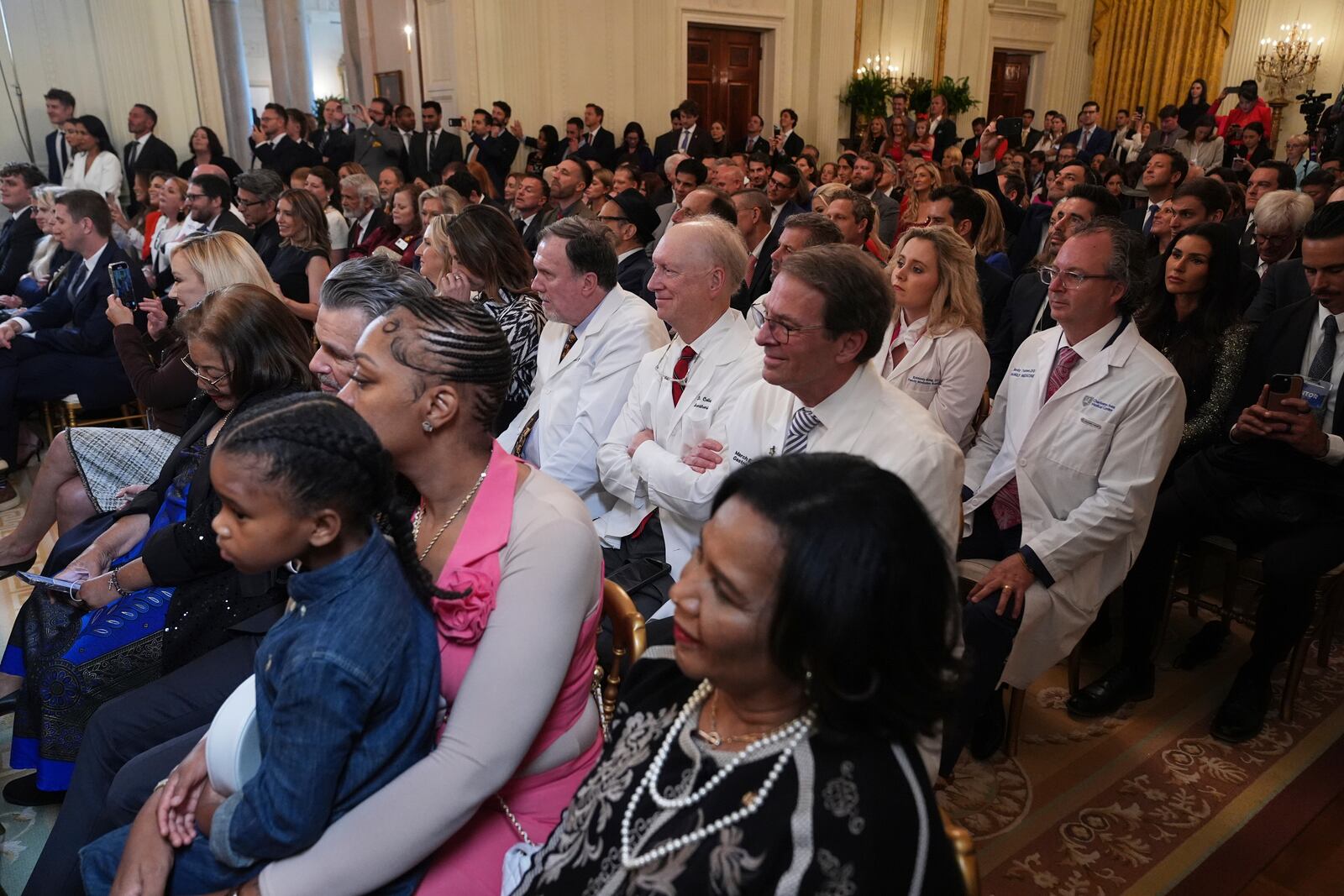 Attendees listen during a Make America Healthy Again (MAHA) Commission Event in the East Room of the White House, Thursday, May 22, 2025, in Washington. (AP Photo/Jacquelyn Martin)