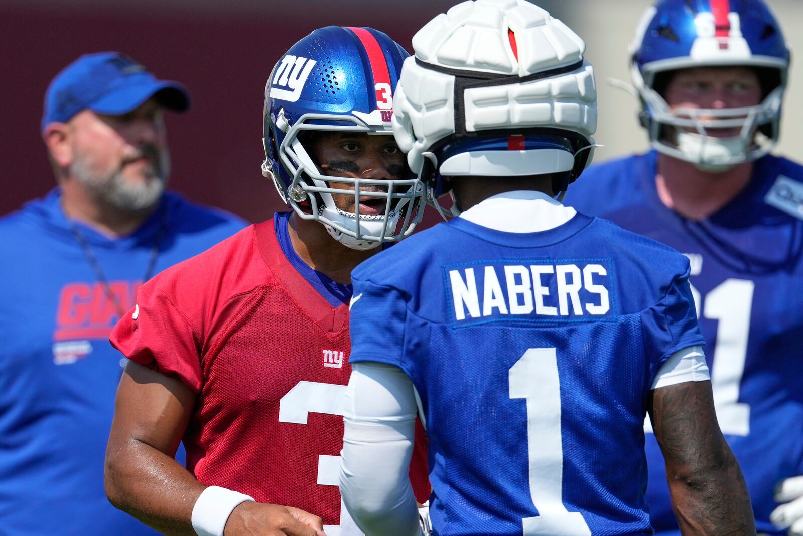 New York Giants quarterback Russell Wilson, left, talks with Malik Nabers (1) during a practice at the team's NFL football training camp in East Rutherford, N.J., Thursday, July 24, 2025. (AP Photo/Seth Wenig)