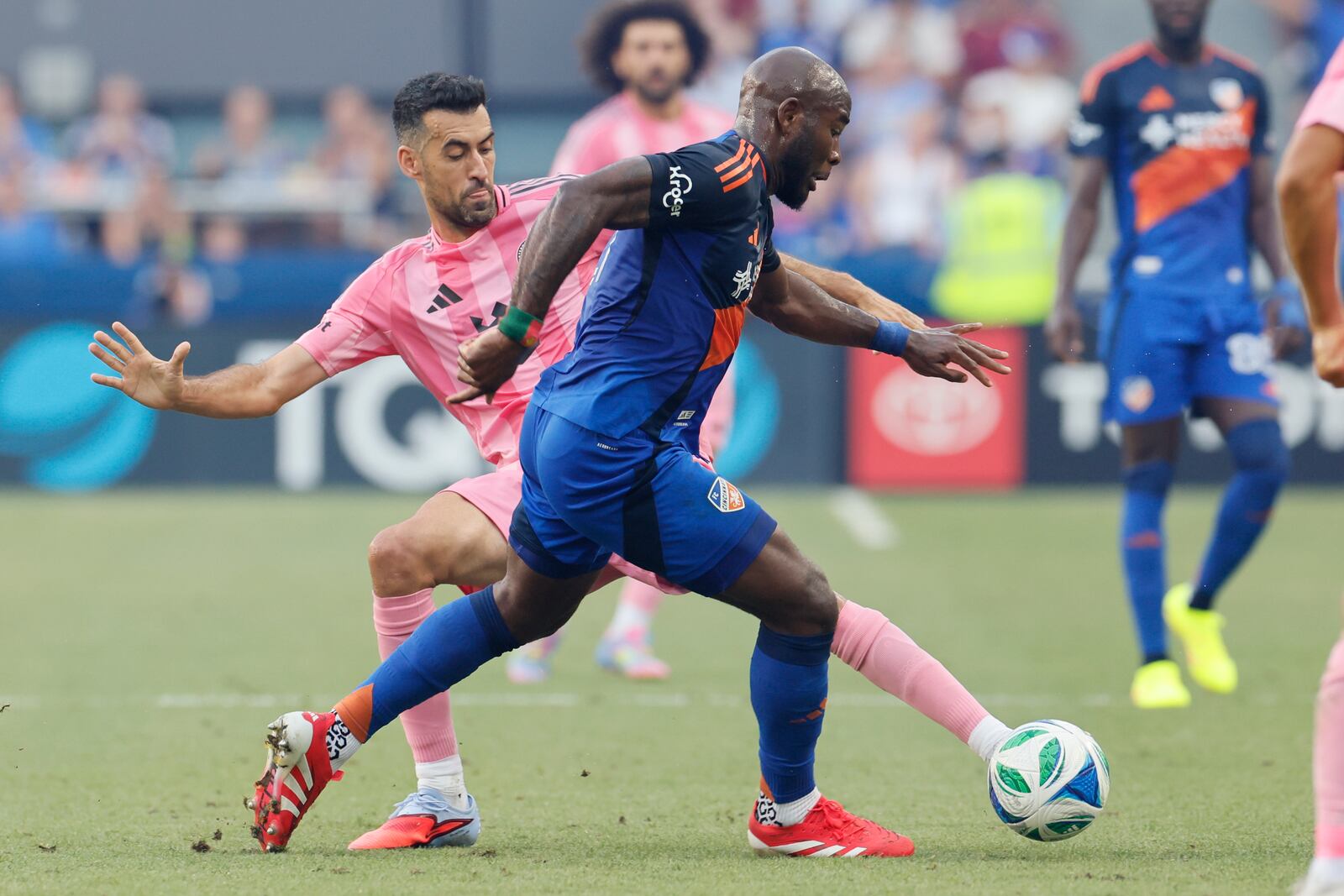Inter Miami's Sergio Busquets, left, tries to stop the ball against FC Cincinnati's Tah Brian Anunga during the first half of an MLS soccer match, Wednesday, July 16, 2025, in Cincinnati. (AP Photo/Jay LaPrete)