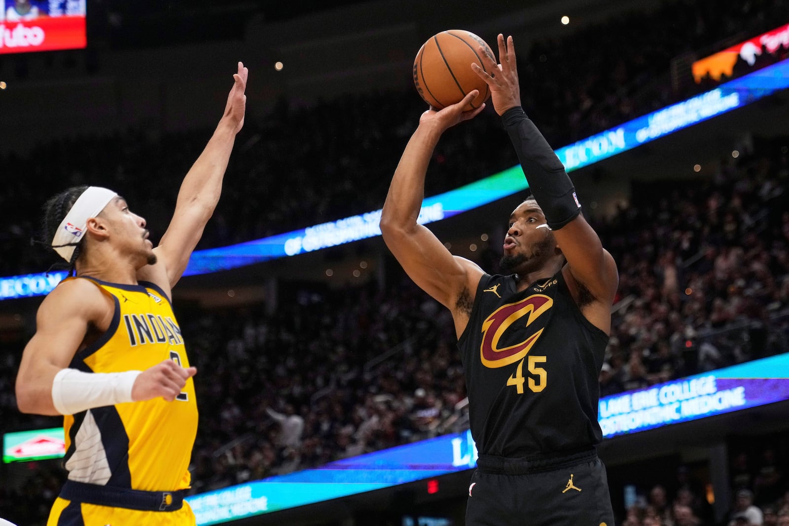 Cleveland Cavaliers guard Donovan Mitchell, right, shoots as Indiana Pacers guard Andrew Nembhard defends during the second half in Game 5 of an Eastern Conference semifinal NBA basketball playoff Tuesday, May 13, 2025, in Cleveland. (AP Photo/Sue Ogrocki)