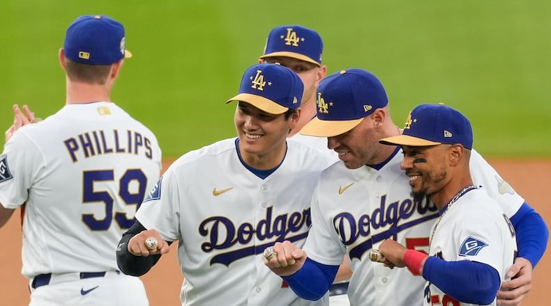 Los Angeles Dodgers Shohei Ohtani, Freddie Freeman and Mookie Betts pose with their rings during a World Series Champion ring ceremony prior to a baseball game against the Arizona Diamondbacks in Los Angeles, Friday, March 27, 2026. (AP Photo/Caroline Brehman)