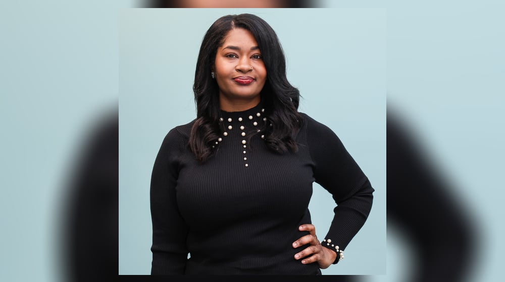 Stacey Harden poses at Daybreak Dayton on Wednesday, Dec. 17. Harden, who is now a massage therapist, credits her time with the organization for helping her. BRYANT BILLING/STAFF