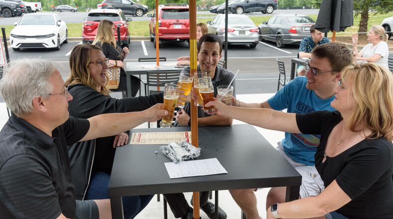 Patrons enjoy the new Warped Wing Brewery & Smokery, located at 6602 Executive Boulevard in Huber Heights next to the Rose Music Center at The Heights. TOM GILLIAM / CONTRIBUTING PHOTOGRAPHER