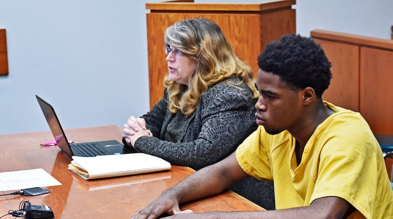 A 16-year-old Middletown teen will be tried as an adult following a hearing Friday, Aug. 10 in Butler County Juvenile Court. Gonnii White, sitting with attorney Dawn Garrett, is charged with murder and participating in a criminal gang in the shooting death of Joseph Davis, 17, near the corner of Woodlawn Avenue and Garfield Street during the late night hours of May 29. NICK GRAHAM/STAFF