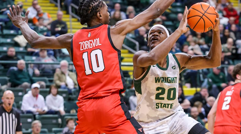 Wright State sophomore guard Andrea Holden shoots with pressure from Youngstown State's Imanuel Zorgvol during a Horizon League game on Thursday, Jan. 15, 2026 at Ervin J. Nutter Center in Fairborn. BRYANT BILLING/STAFF