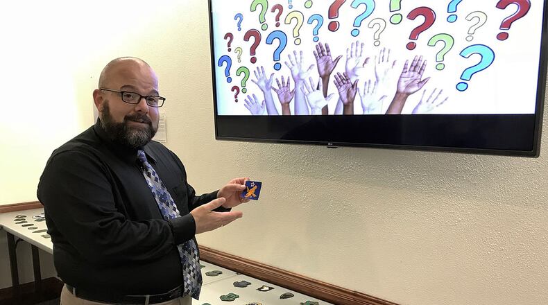 Jack Waid, a historian at Air Force Materiel Command Headquarters, explains the significance of heraldic symbols during a lunch-and-learn lecture on emblems and patches at AFMC headquarters. Since early recorded history, warring tribes often carried banners or flags marked with emblems to represent factions and motivate their warriors to fight for the cause; it is to this historical tradition that we can trace the evolution of military emblems and patches, according to Waid. (U.S. Air Force photo/Marisa Alia-Novobilski)