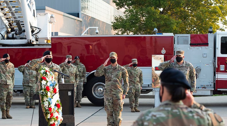 Airmen attending the ceremony Sept. 10 commemorating the 20th anniversary of the 9/11 attacks salute during the playing of taps after a wreath-laying at Fire Station One on Wright-Patterson Air Force Base. Firefighters, Explosive Ordnance Disposal Flight members and base leadership attended the ceremony, which was streamed online for the rest of the Wright-Patt community. U.S. AIR FORCE PHOTO/R.J. ORIEZ