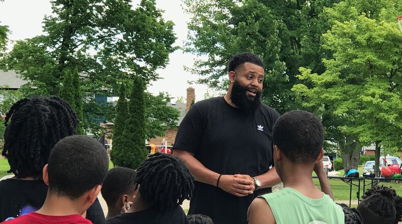 Anthony Parker, founder of the non-profit Extraordinary Men Mentoring Group and the head football and basketball coach at West Carrollton High, sharing insights with his summer campers Thursday. Tom Archdeacon/CONTRIBUTED