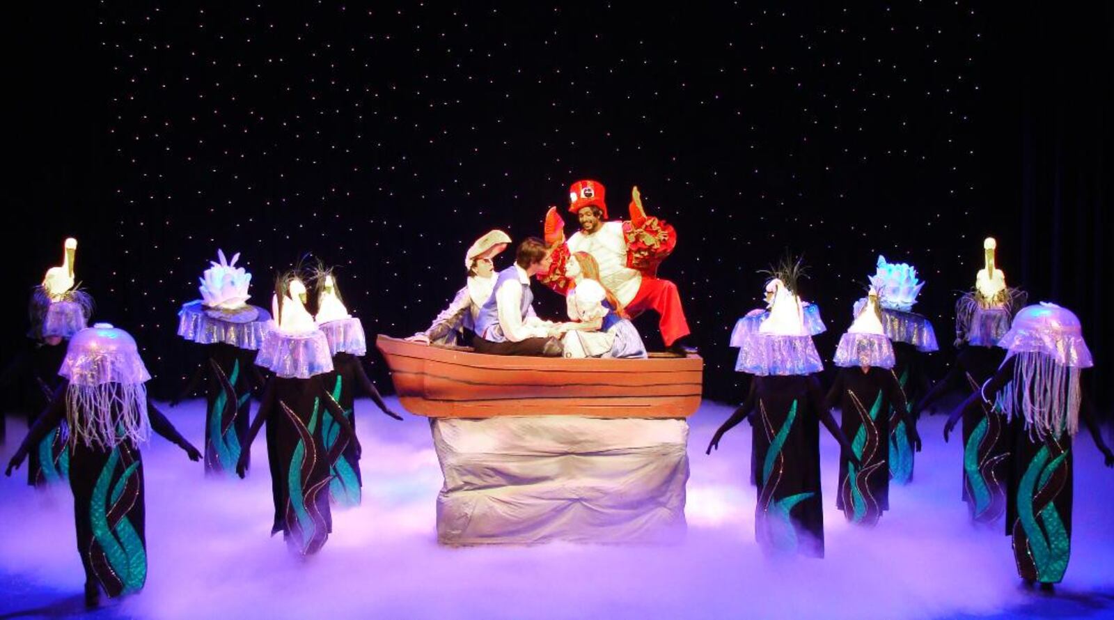 La Comedia Dinner Theatre's production of "The Little Mermaid" features "Kiss the Girl," showcasing (center) Jeremy Smith as Prince Eric, Anirudth Keshamouni as Sebastian and KatieAnn Bonavita as Ariel.