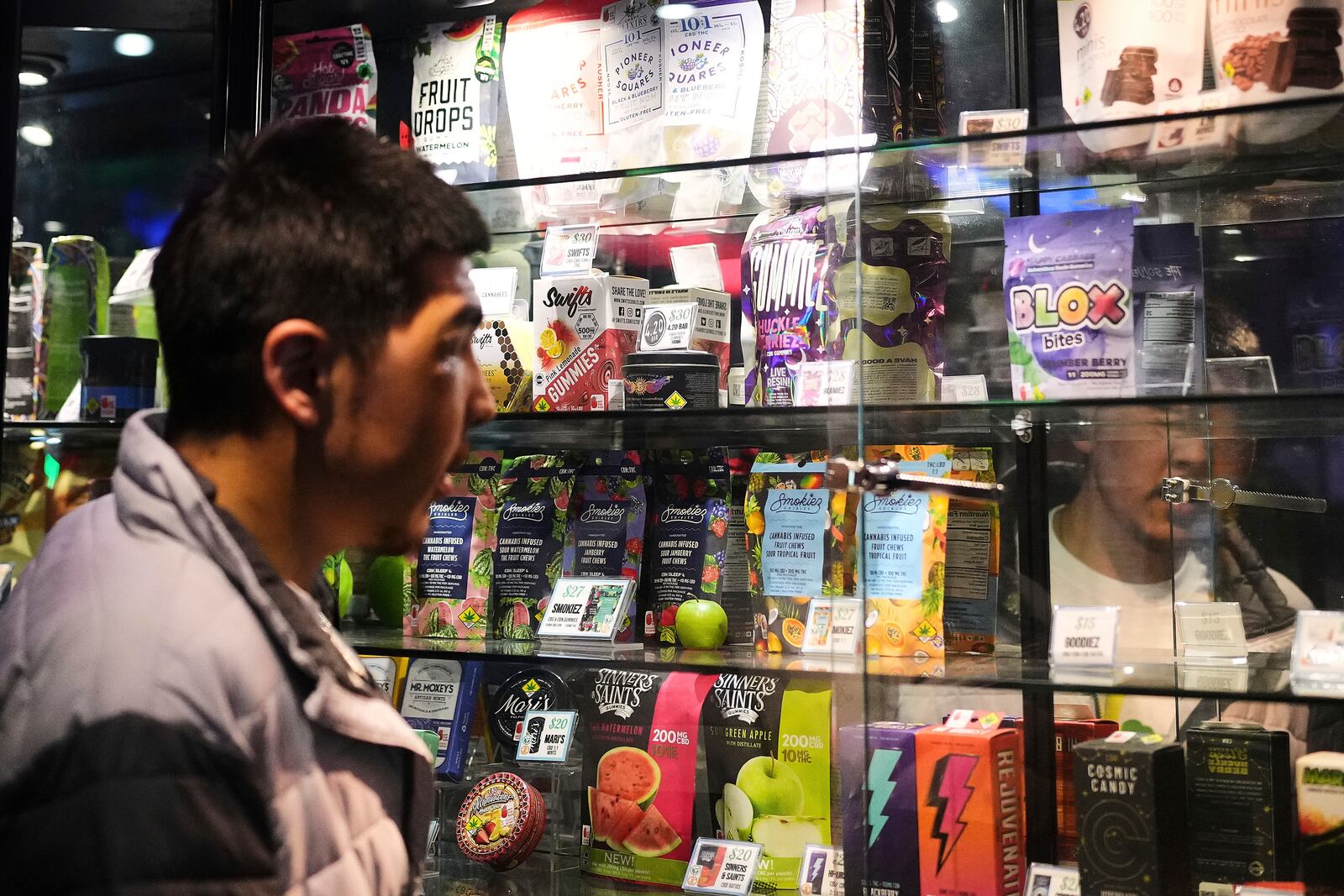 Kobe Norell shops for products at Have a Heart cannabis dispensary Sunday, April 20, 2025, in Seattle. (AP Photo/Lindsey Wasson)