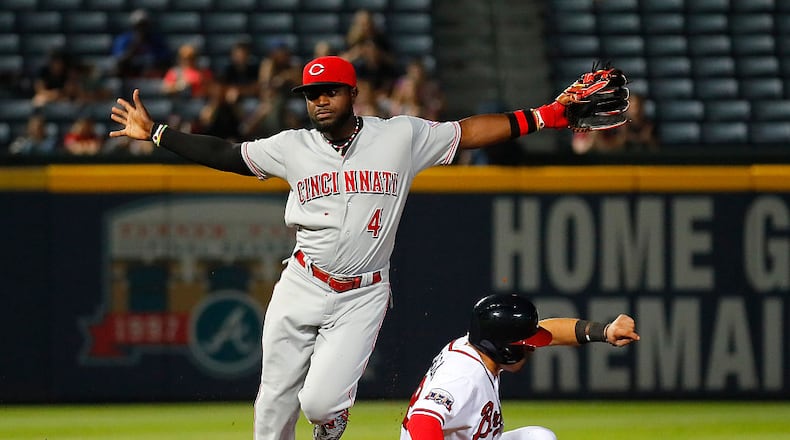 ATLANTA, GA - JUNE 14: Brandon Phillips #4 of the Cincinnati Reds reacts after turning a double play over Jace Peterson #8 of the Atlanta Braves to end the ninth inning and take a 3-1 victory at Turner Field on June 14, 2016 in Atlanta, Georgia. (Photo by Kevin C. Cox/Getty Images)