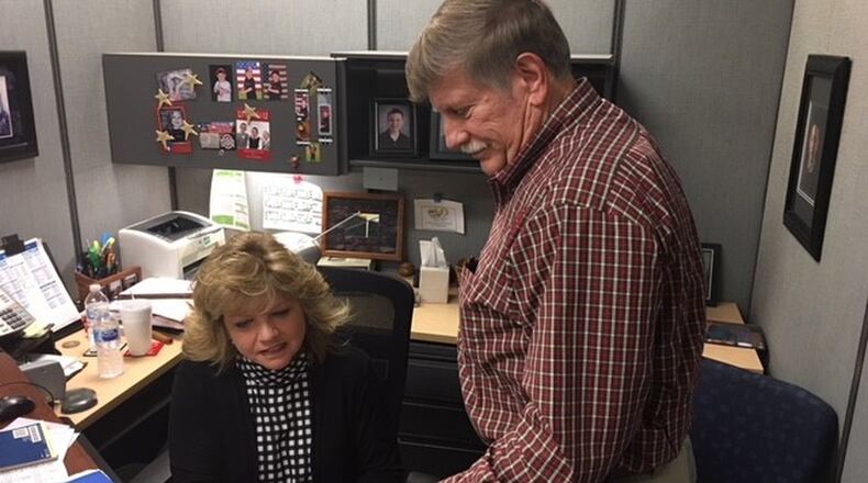 Debra Cook, supervisor accountant of Financial Management Analysis Two, 88th Comptroller Squadron, and Keith Tarnovich, chief of operation support, Financial Management Analysis Two, 88th Comptroller Squadron, demonstrate how the Financial Management Analysis Flight takes time to review and certify end-of-year documents from more than 100 tenant organizations at Wright-Patterson Air Force Base. (U.S. Air Force photo/Kimberly Gaither)