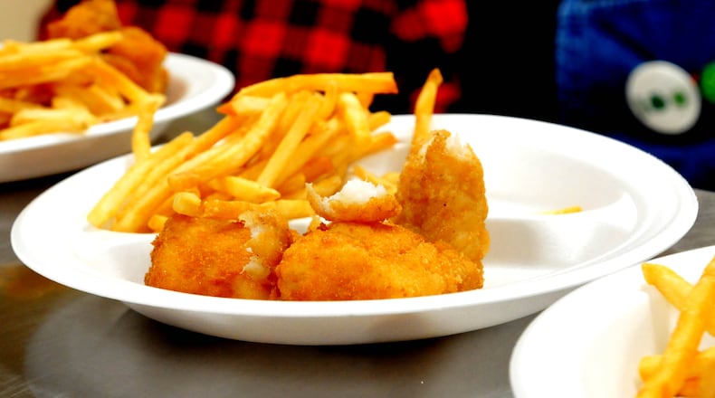 Chaminade-Julienne High School's Blue Green Club hosted its annual CJ Fish Fry on Saturday, March 18. The event, which draws alumni and supporters of the school as well as members of the community, featured a meal of fish, sausage and sides. Visitors also had the opportunity to play games of chance and participate in a silent auction. DAVID A. MOODIE/CONTRIBUTING PHOTOGRAPHER