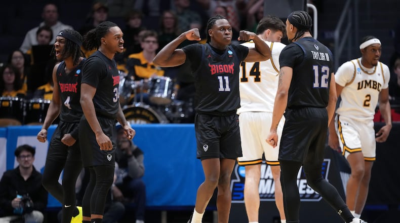 Howard guard Ose Okojie (11), center, reacts after scoring and drawing a foul during the first half in a First Four college basketball game in the NCAA Tournament against UMBC, Tuesday, March 17, 2026, in Dayton, Ohio. (AP Photo/Kareem Elgazzar)