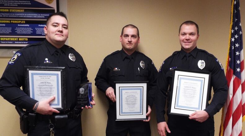 West Carrollton Police Officer John Perry (left) was honored as the department’s 2018 Employee of the Year. He also garnered a perfect attendance award, as did fellow officers Jared Moore (center) and Matthew Harper (right). CONTRIBUTED
