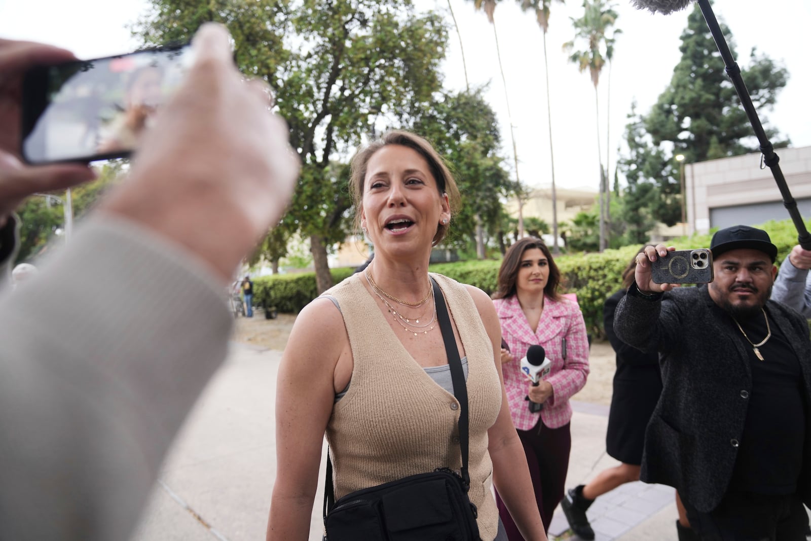 Anamaria Baralt, center, and other family members of Erik and Lyle Menendez arrive in court for a hearing in their case Thursday, April 17, 2025, in Los Angeles. (AP Photo/Damian Dovarganes)