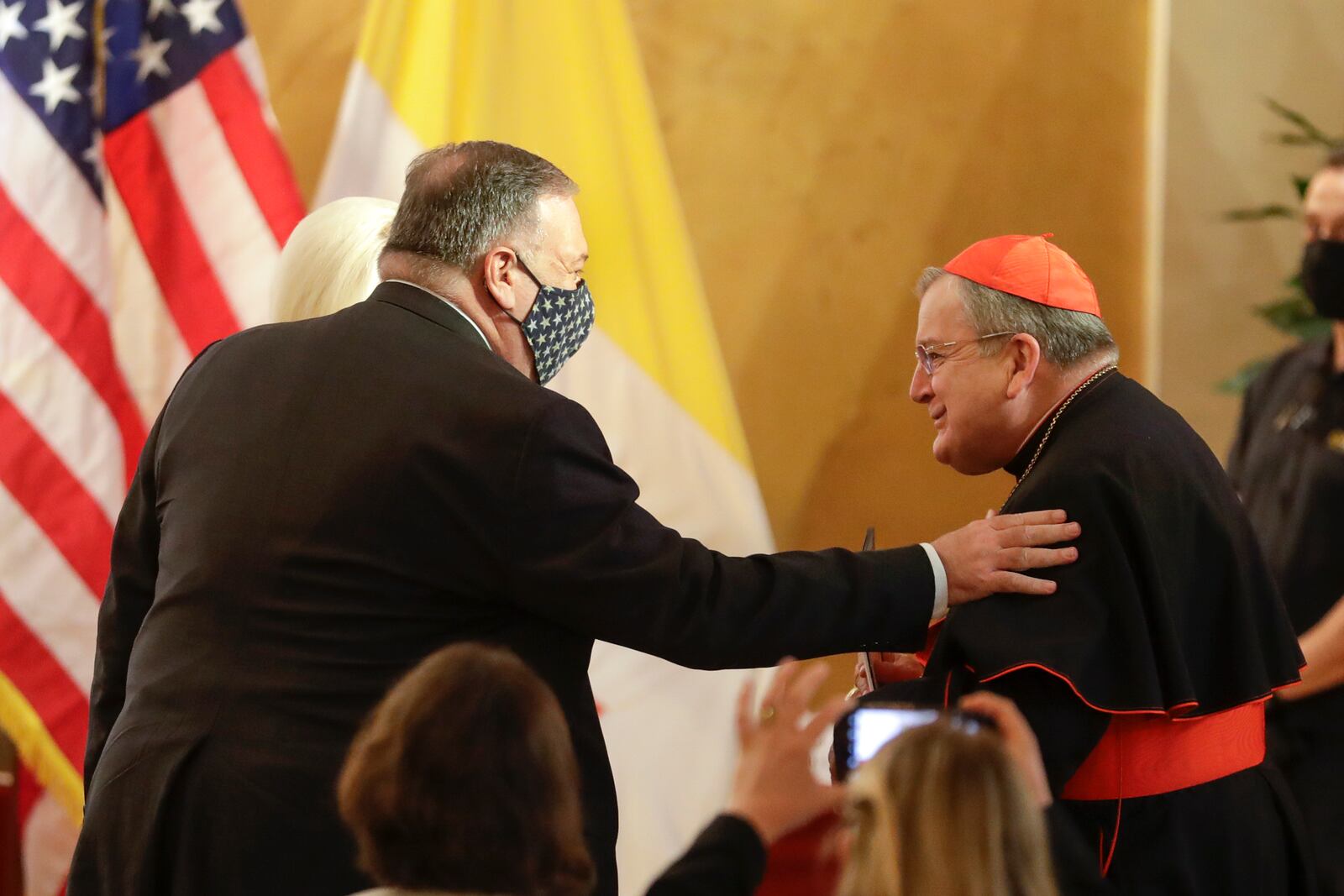 FILE - U.S. Secretary of State Mike Pompeo, left, greets Cardinal Raymond Burke as they attend the "Advancing and Defending International Religious Freedom Through Diplomacy" symposium, in Rome, Sept. 30, 2020. (AP Photo/Andrew Medichini, File)