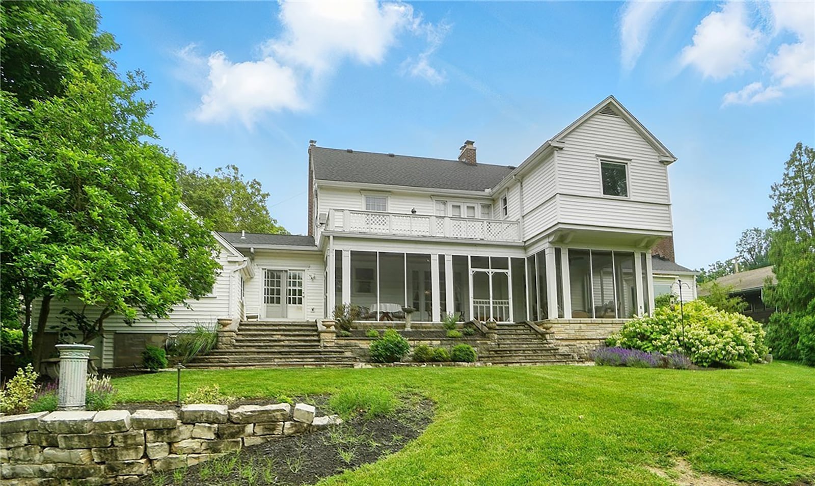 The back of the home has a screened in porch overlooking the heavily landscaped backyard and the Dayton Country Club golf course.