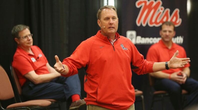 Mississippi football coach Hugh Freeze speaks to the alumni gathered during the Rebel Roadshow as Chancellor Jeff Vitter, left, and Athletic Director Ross Bjork, right, sit nearby, Wednesday evening, April 26, 2017, in Tupelo, Miss. (Lauren Wood/Northeast Mississippi Daily Journal via AP)
