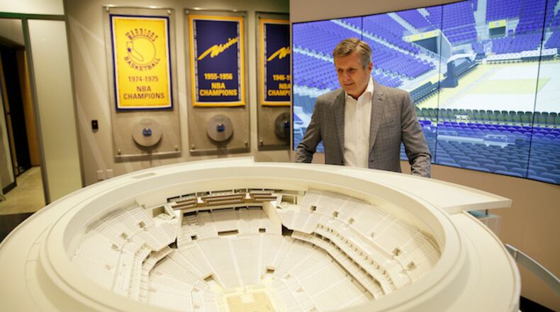 In this photo taken Jan. 24, 2018, Golden State Warriors President and COO Rick Welts looks over a model of Chase Center at the Chase Center Experience in San Francisco. Welts, who turned 65 in January and is the first openly gay NBA executive, can lean not only on the time with the Seattle SuperSonics but also his experience in the league office and with Phoenix to see what things work and don't work when it comes to operating a franchise, to building an arena. (AP Photo/Eric Risberg)