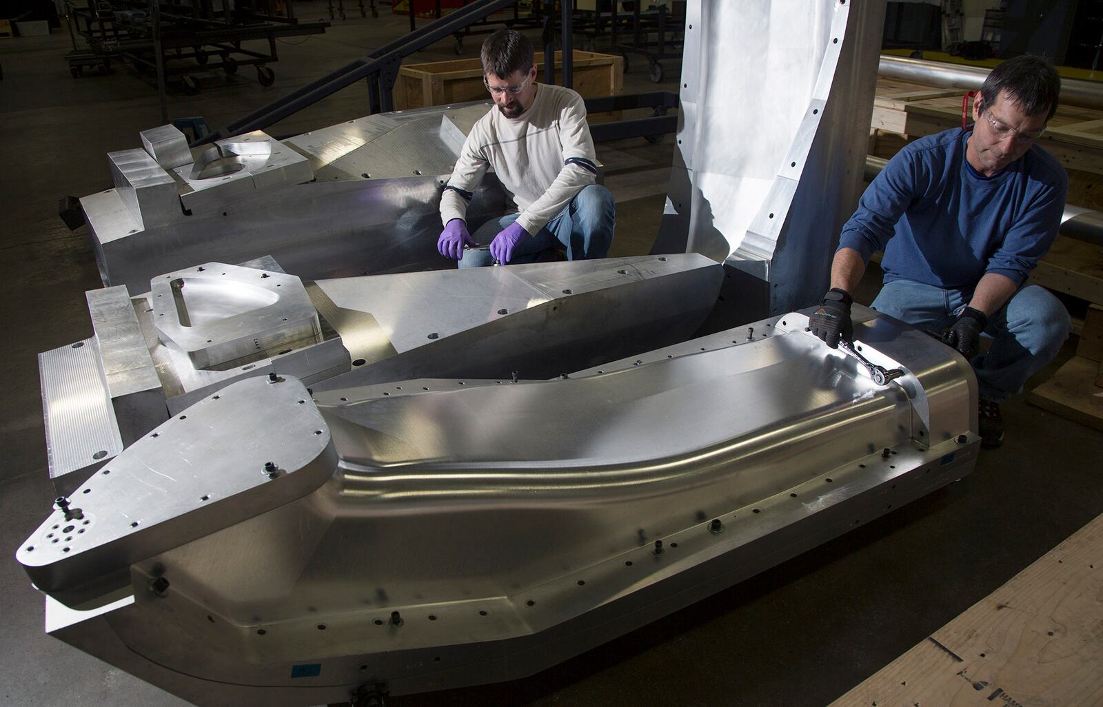 SpinTech senior composite technicians Abe McNutt, left, and Jim Leschansky work on tooling for rocket parts. TY GREENLEES / STAFF