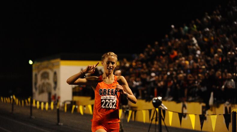 Beavercreek’s Taylor Ewert celebrates her win in the Saturday Night Lights event at Centerville. Greg Billing/CONTRIBUTED