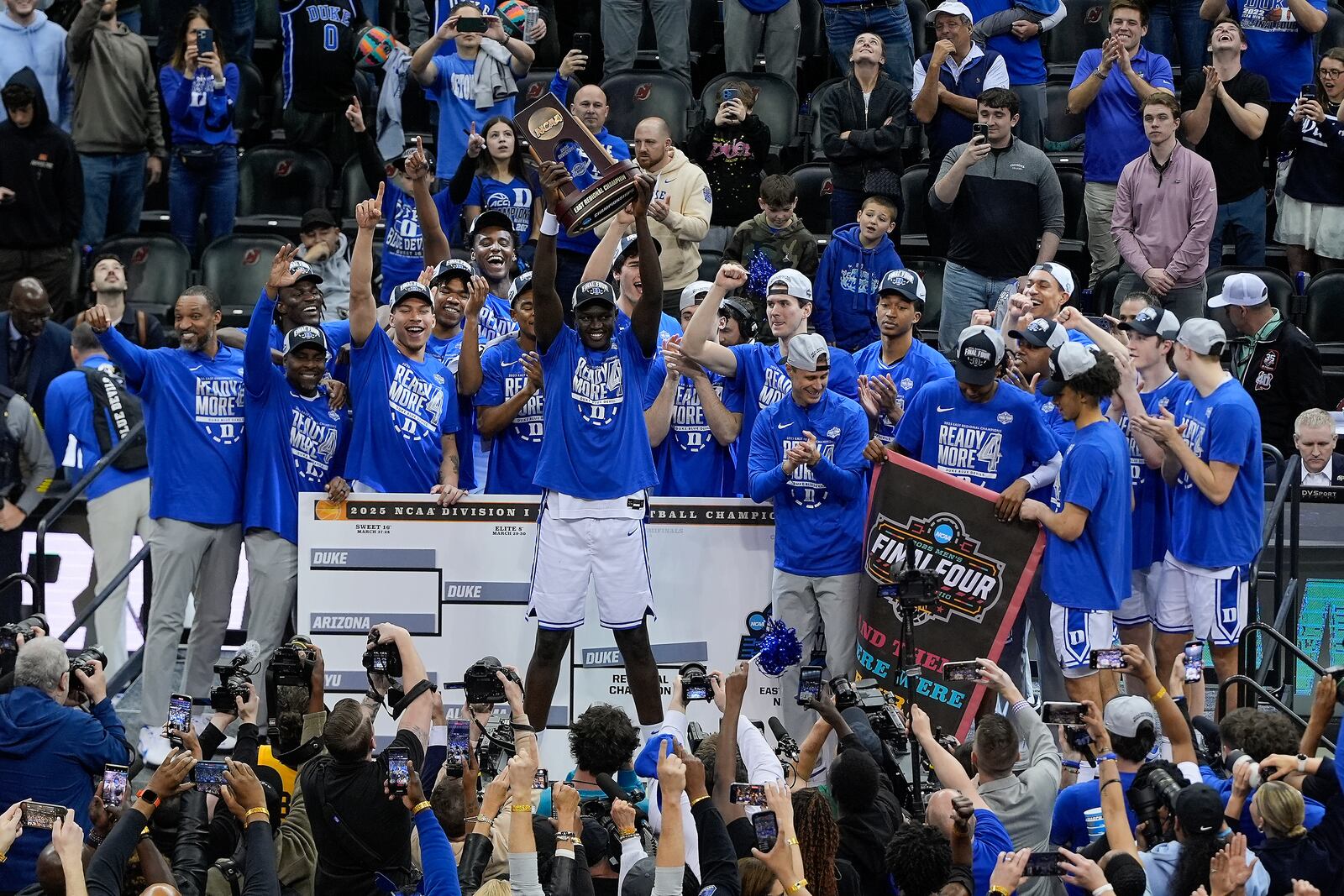 Duke center Khaman Maluach (9) holds up at the East Region championship trophy after Duke defeated Alabama in an Elite Eight round NCAA college basketball tournament game, Saturday, March 29, 2025, in Newark, N.J. (AP Photo/Julia Demaree Nikhinson)
