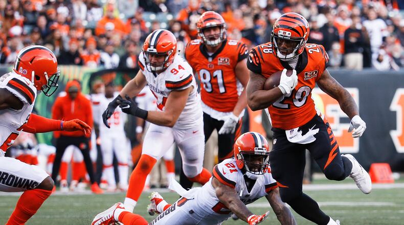 Cincinnati Bengals running back Joe Mixon (28) runs the ball past Cleveland Browns cornerback Jamar Taylor (21) in the second half of an NFL football game, Sunday, Nov. 26, 2017, in Cincinnati. (AP Photo/Frank Victores)