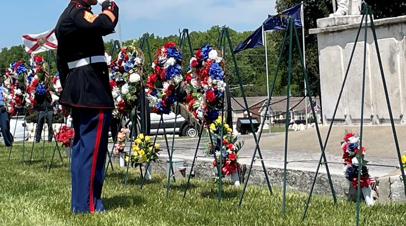Members representing each branch of the military services set wreaths during Memorial Day ceremonies Monday at the Dayton National Cemetery. NICK BLIZZARD/STAFF