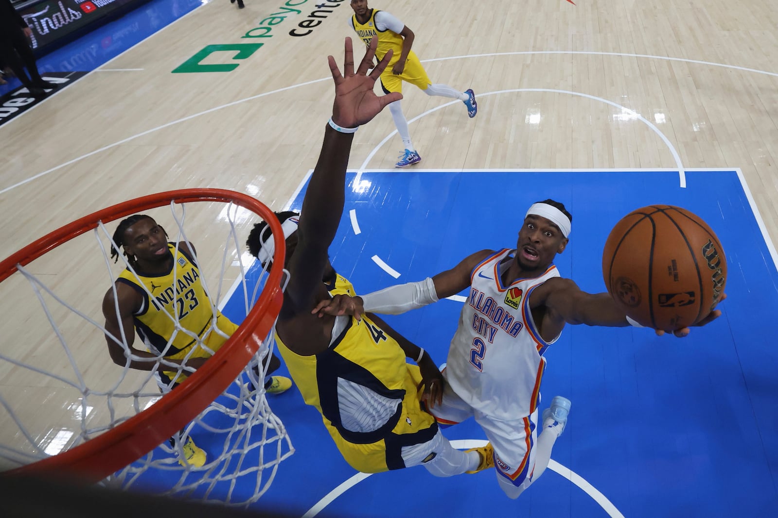 Oklahoma City Thunder guard Shai Gilgeous-Alexander (2) shoots around Indiana Pacers forward Pascal Siakam during the second half of Game 5 of the NBA Finals basketball series, Monday, June 16, 2025, in Indianapolis. (Matthew Stockman/Pool Photo via AP)