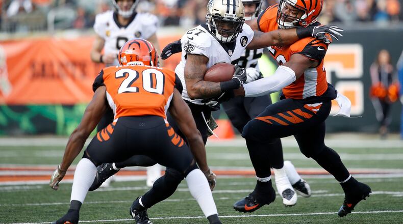 CINCINNATI, OH - NOVEMBER 11: Dwayne Washington #27 of the New Orleans Saints attempts to run the ball past Preston Brown #52 of the Cincinnati Bengals and KeiVarae Russell #20 during the fourth quarter at Paul Brown Stadium on November 11, 2018 in Cincinnati, Ohio. New Orleans defeated Cincinnati 51-14. (Photo by Joe Robbins/Getty Images)