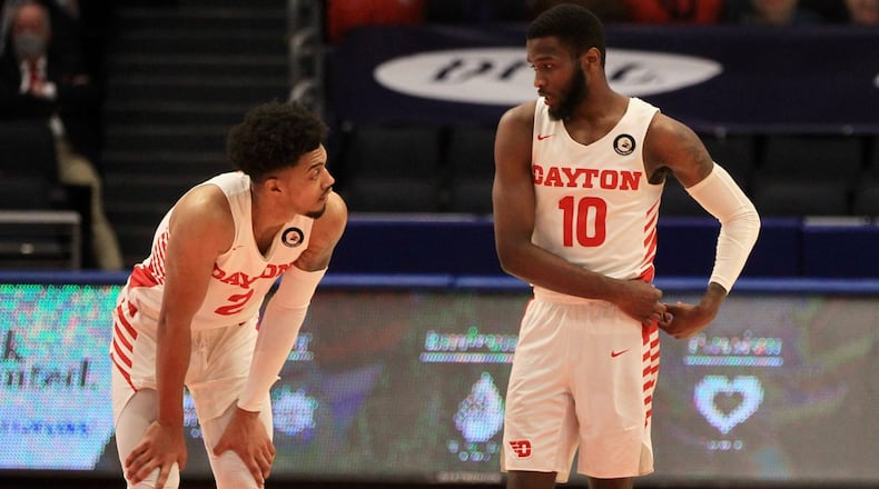 Dayton's Ibi Watson and Jalen Crutcher talk during a game against Duquesne on Wednesday, Jan. 13, 2021, at UD Arena. David Jablonski/Staff