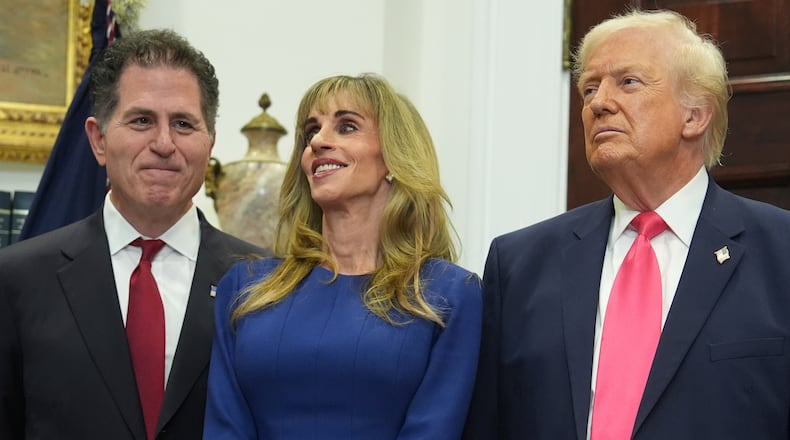 Michael Dell, left, his wife Susan and President Donald Trump listen during an event on "Trump Accounts" for kids in the Roosevelt Room of the White House, Tuesday, Dec. 2, 2025, in Washington. (AP Photo/Evan Vucci)