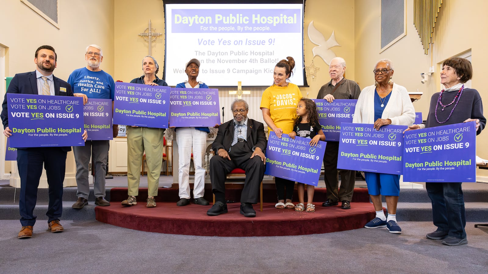 Volunteers in support of the passage of Issue 9 recite a chant urging voters to approve the levy during a meeting on Tuesday, Sept. 23 at College Hill Community Church in West Dayton. If passed, the levy would raise $2 million annually to support the creation of a new public hospital in West Dayton. BRYANT BILLING / STAFF